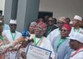 Jerry Gana Presents PDP Certificate To Jonathan 